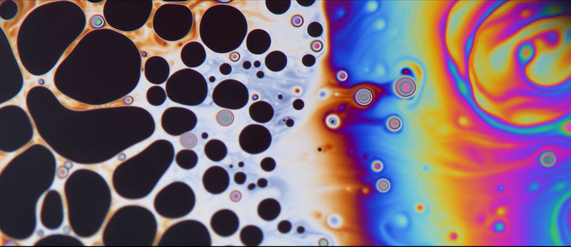 This image demonstrates the behavior of soap bubbles to study the formation of foams. According to the EPSRC website, it was “taken using a highly customized set-up comprising two Quality Street biscuit tins, an oven tray, parts of a Tesco water bottle, a piece of transparency paper, Fairy Liquid, a builder’s lamp and a DSLR camera, a Nikon D500 with a 105mm VR macro lens.” By Li Shen - Imperial College London (Image via EPSRC)